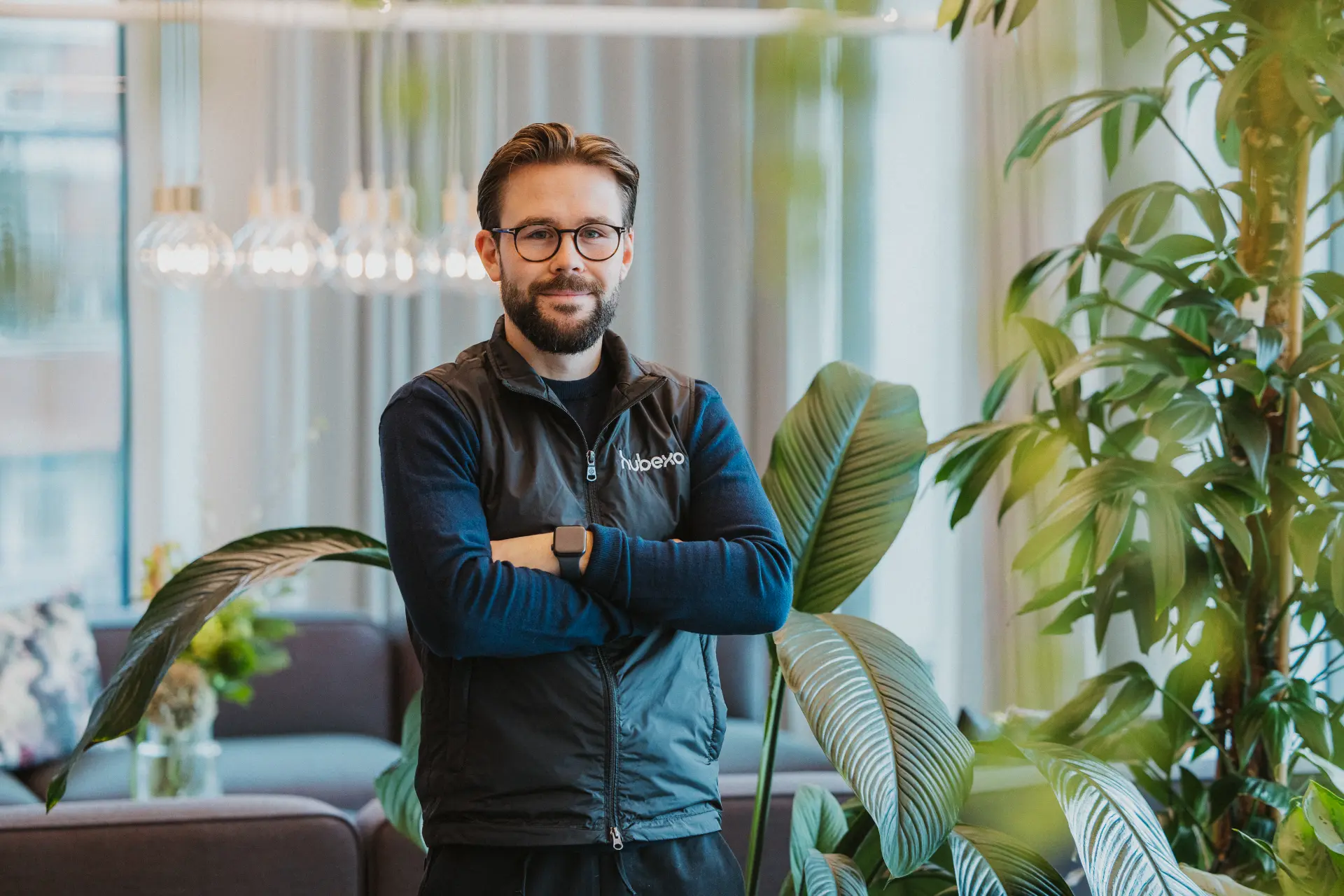 Hubexo colleague standing in a bright office space